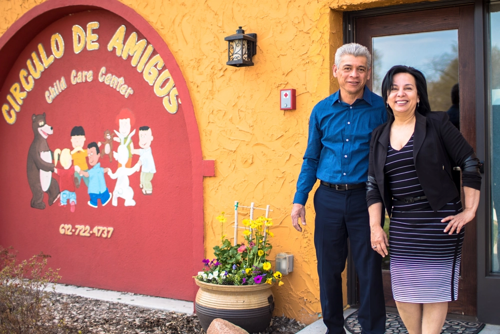 man and woman standing in front of building with sign reading "Circulo Des Amigos"